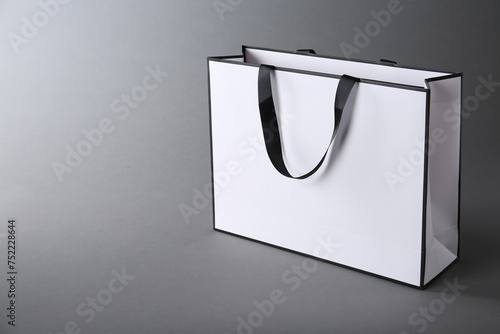 One paper bag on grey background, space for text. Mockup for design © New Africa