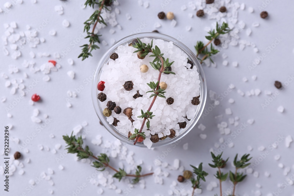 Salt with peppercorns and thyme in bowl on light table, flat lay Salt with peppercorns and thyme in bowl on light table, flat lay