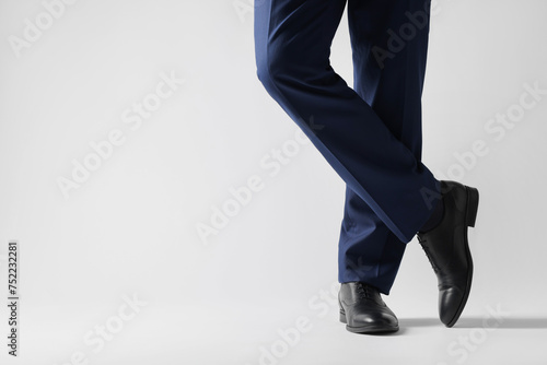 Businessman in leather shoes on white background, closeup