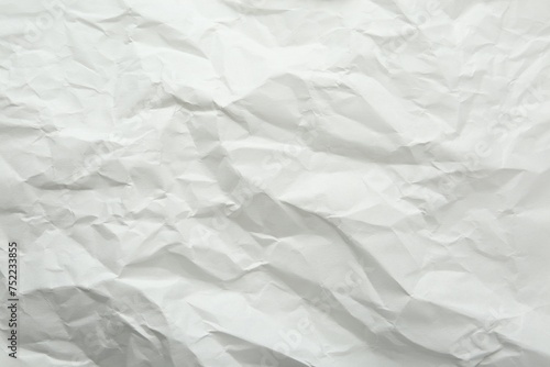 Crumpled notebook sheet as background, top view