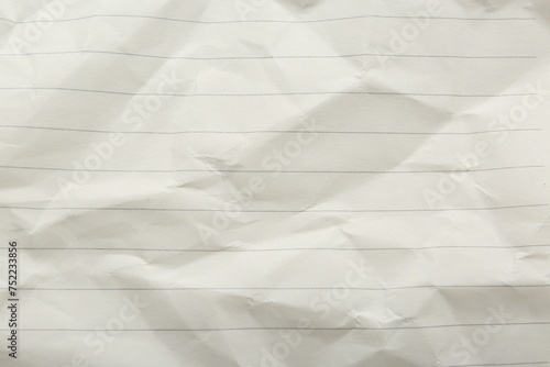 Crumpled lined notebook sheet as background, top view