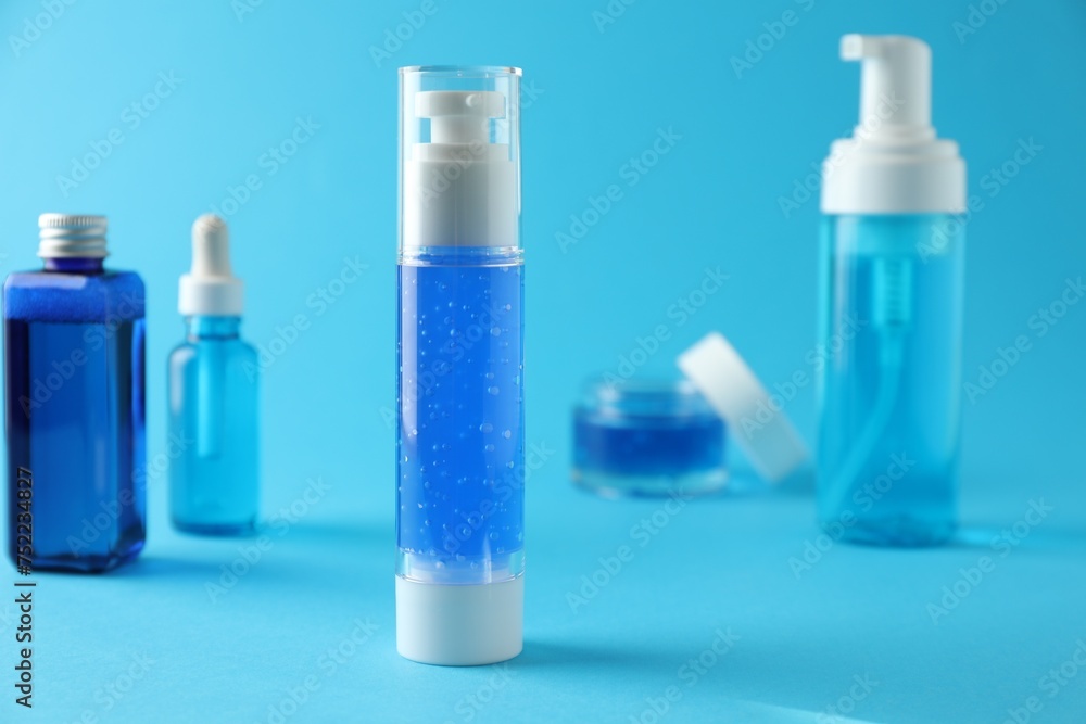 Different cosmetic products on light blue background