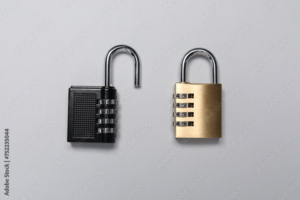 Steel combination padlocks on grey background, top view Steel combination padlocks on grey background, top view