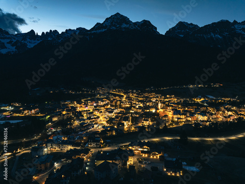 Aerial drone view of Andalo town at night with mountains background in winter. Snow covered Italian Dolomites at winter.Ski resort Paganella Andalo  Trentino-Alto Adige  ItalyItalian Dolomites