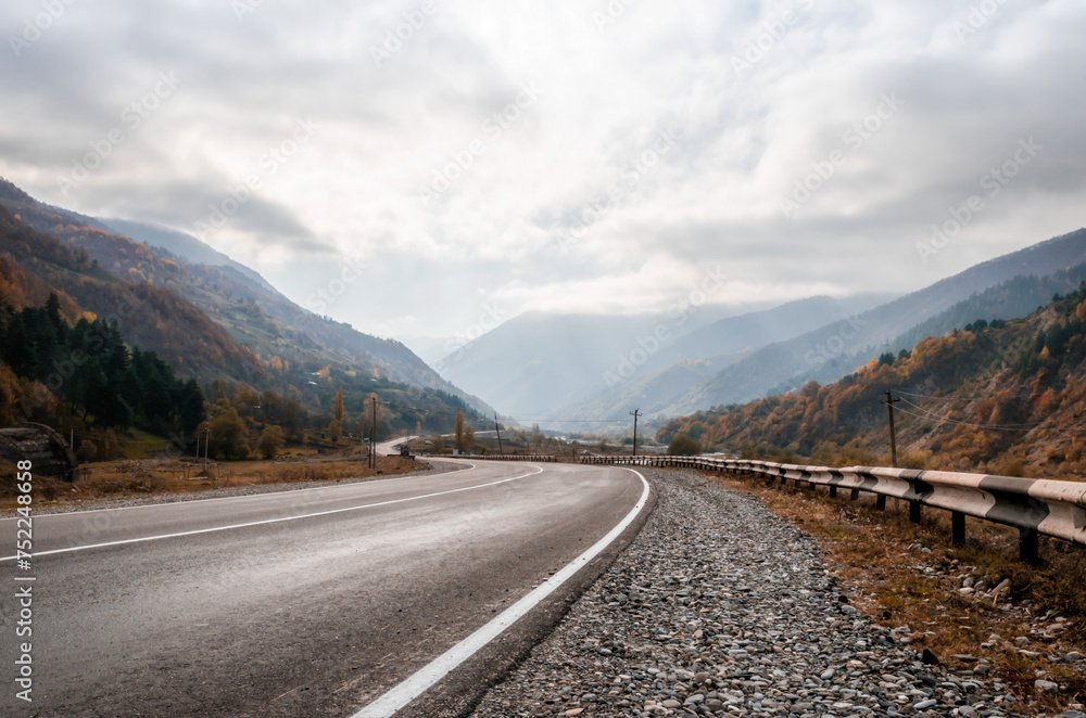 Fototapeta premium background mountain road and sky with clouds in the afternoon in Georgia