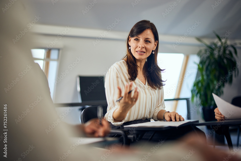 A brunette woman explaining to the other people her feelings, during the psychotherapy. A brunette woman explaining to the other people her feelings, during the psychotherapy.