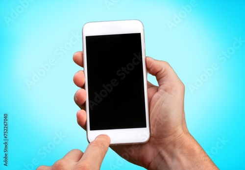 Human hands hold smartphone with blank screen