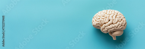 Brain model symbolizes autism, dementia, Alzheimer's awareness on faded blue backdrop, minimalist 