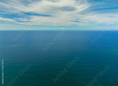 Aerial view of beautiful deep blue sea with waves and sky with clouds, seascape. Mindanao, Philippines.