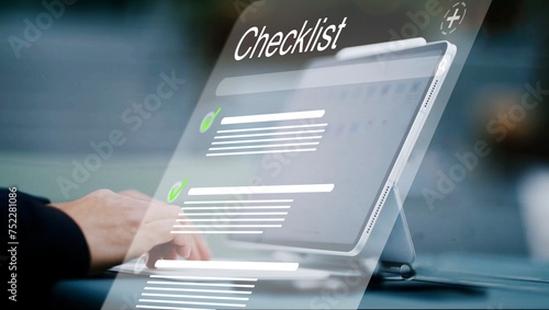 ictional checklist software with a checklist and checked off points hovering as a hologram in front of a tablet computer with keyboard, management tool, to-do-list, tasks, business, lists photo