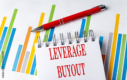 LEVERAGE BUYOUT text on a notebook with chart and pen business concept photo