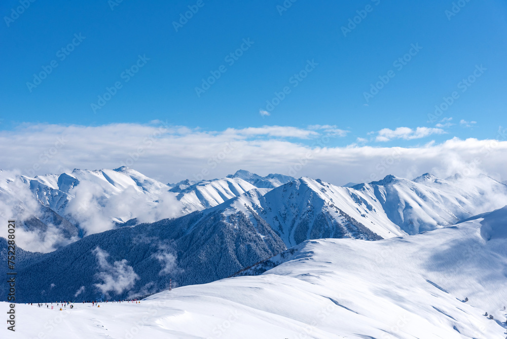 Beautiful landscape of the Arkhyz ski resort with mountains, snow, forest on sunny winter day. Caucasus Mountains, Russia. Beautiful landscape of the Arkhyz ski resort with mountains, snow, forest on sunny winter day. Caucasus Mountains, Russia.
