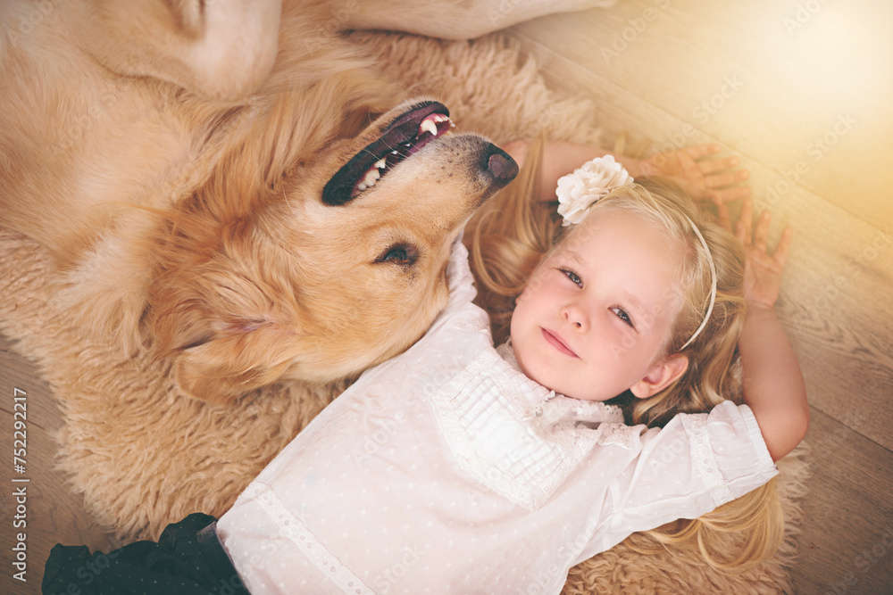 Girl, dog and love in portrait for bonding, care and pet for support on floor of living room in home. Child, golden retriever and relax with puppy in apartment, top view and companion in childhood Girl, dog and love in portrait for bonding, care and pet for support on floor of living room in home. Child, golden retriever and relax with puppy in apartment, top view and companion in childhood