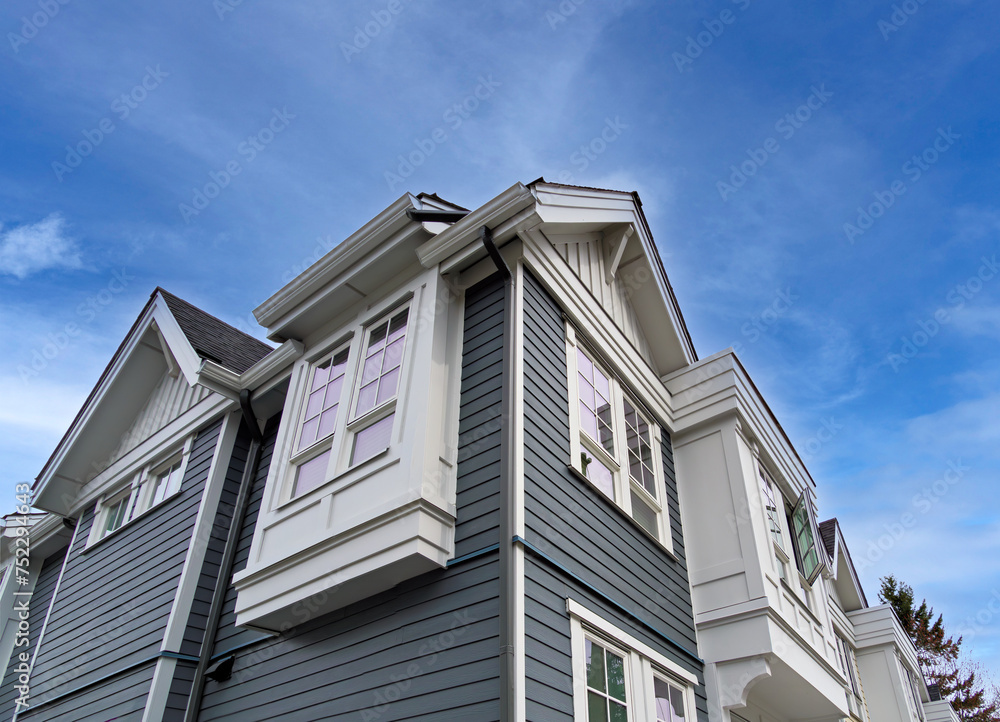 Top of residential townhouse on blue sky background Top of residential townhouse on blue sky background