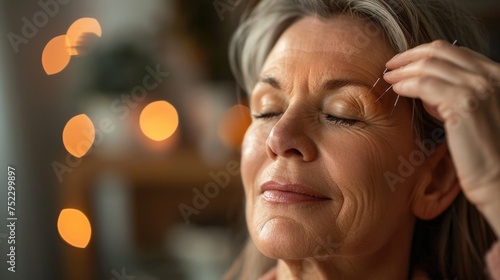 Middle-aged woman trying out acupuncture therapy to alleviate menopause symptoms, showing openness to alternative treatments photo