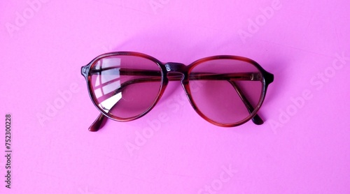 Glasses on a pink background. View from above. Place for text.