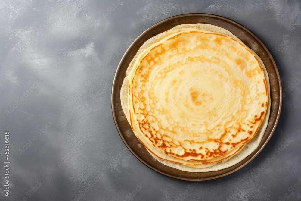 Thin pancakes or russian blini on gray stone background. Top view. Copy space. Thin pancakes or russian blini on gray stone background. Top view. Copy space.