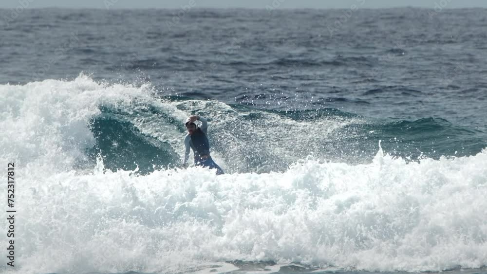 Surfer rides the wave in the Maldives Surfer rides the wave in the Maldives