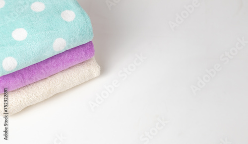 A stack of colorful towels on a white background