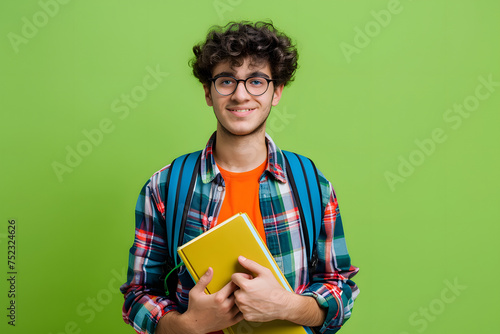 student with backpack and books, isolated on an apple green background, signifying learning and education