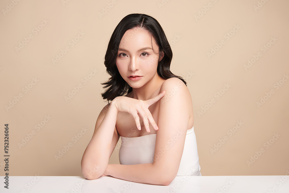Beautiful young asian woman with clean fresh skin on beige background, Face care, Facial treatment, Cosmetology, beauty and spa, Asian women portrait. Beautiful young asian woman with clean fresh skin on beige background, Face care, Facial treatment, Cosmetology, beauty and spa, Asian women portrait.