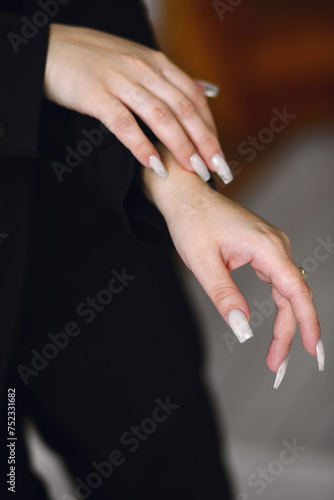 Close up photo of womans hands with white manicure. Copy space for text