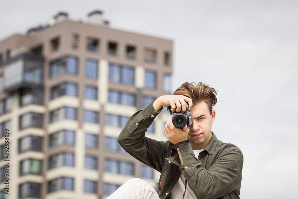 The guy looks at the camera and takes pictures The guy looks at the camera and takes pictures
