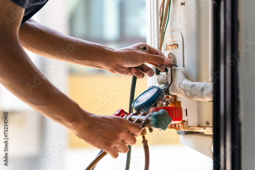 Repairman fix air conditioning systems, Male technician service for repair and maintenance of air conditioners.