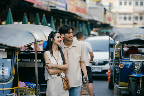 Asian couple tourists exploring and shopping in local market during holiday. © PaeGAG