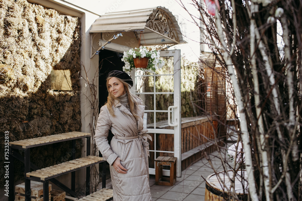 Woman in Long Coat Standing in Front of Building Woman in Long Coat Standing in Front of Building