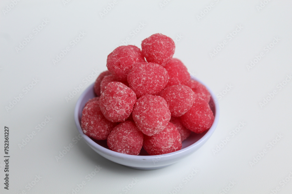 Soursop candy, in pink color and ball shaped, coated by sugar. Isolated on white background Soursop candy, in pink color and ball shaped, coated by sugar. Isolated on white background