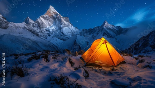 A glowing tent pitched in snowy terrain under a sky full of stars and towering mountain peaks