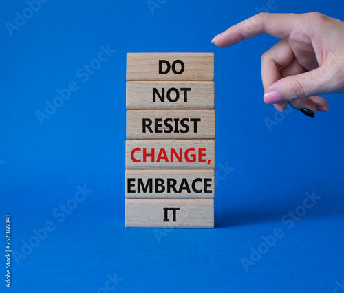 Do not resist change embrace it symbol. Concept words Do not resist change embrace it on wooden blocks. Businessman hand. Beautiful blue background. Business concept. Copy space.