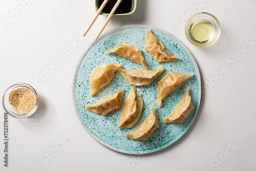 Overhead view of bolied gyoza chinese dumplings on plate food photo