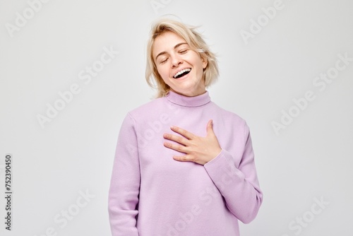 Portrait of smiling woman hands on chest expressing gratitude or joy isolated on white background