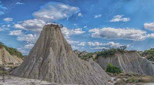 view of Aliano badlands (calanchi), landscape made of clay sculptures eroded by the rainwater, Basilicata region, southern Italy photo