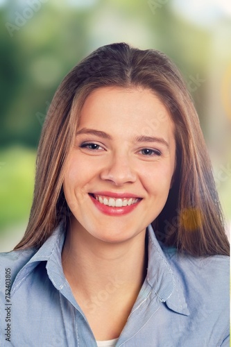 Young beautiful female smiling at otdoor photo