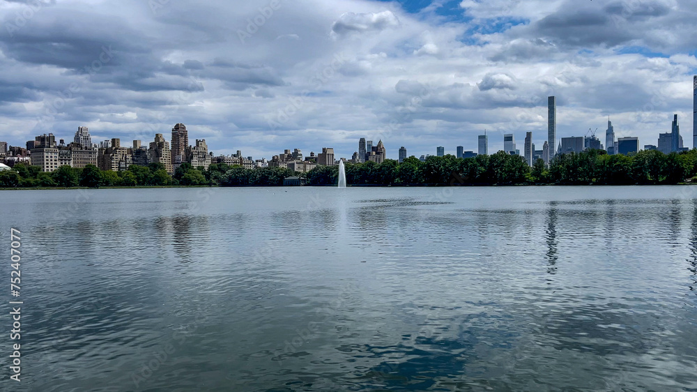 Strolling along the large lake in Central Park which is a public urban park located in the metropolitan district of Manhattan, New York City, (USA).