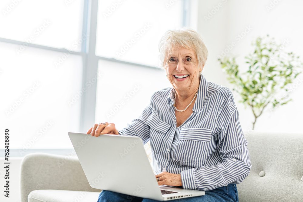 senior women using a laptop while sitting at the office senior women using a laptop while sitting at the office