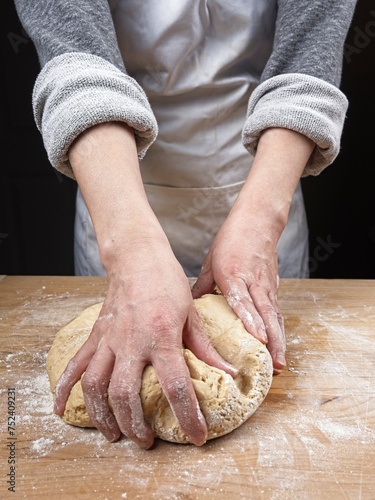 Grabbing the dough for the next knead.