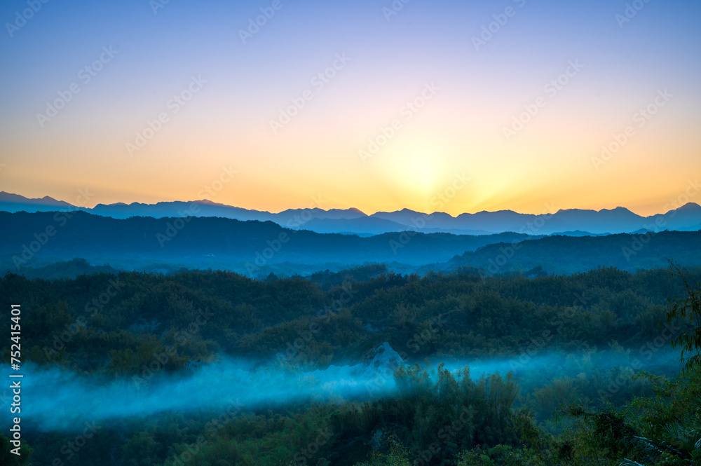 In the early morning, the sun rises from behind the mountains. The Erliao tribe in Zuozhen enjoys the sunrise landscape, Tainan City, Taiwan.