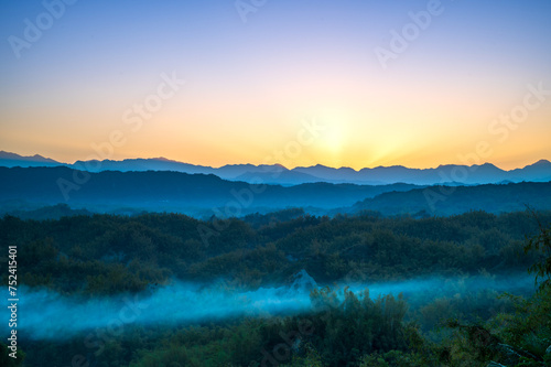 In the early morning, the sun rises from behind the mountains. The Erliao tribe in Zuozhen enjoys the sunrise landscape, Tainan City, Taiwan.