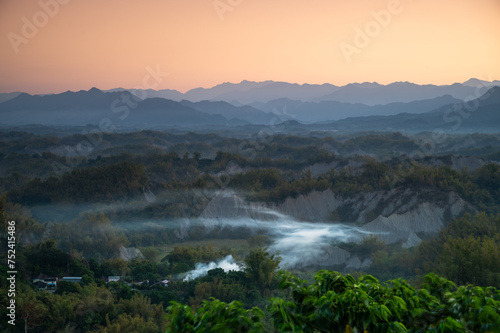 In the morning  smoke curls up from the valley and the bamboo forest is green. The Erliao tribe in Zuozhen enjoys the sunrise landscape  Tainan City  Taiwan.