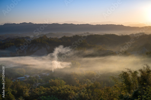 In the morning, smoke curls up from the valley and the bamboo forest is green. The Erliao tribe in Zuozhen enjoys the sunrise landscape, Tainan City, Taiwan.