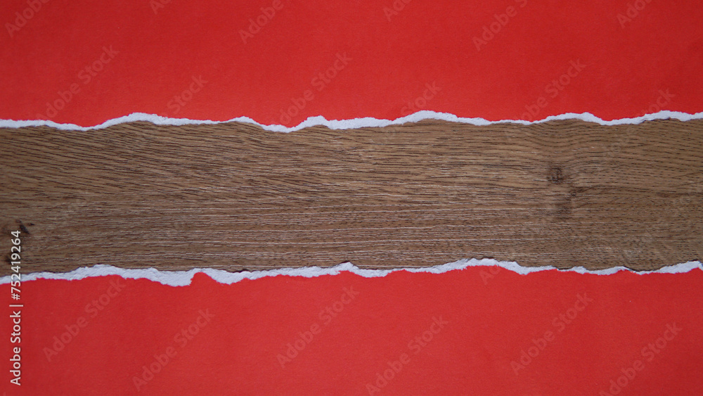 Torn red paper sheet isolated on wooden texture background Torn red paper sheet isolated on wooden texture background