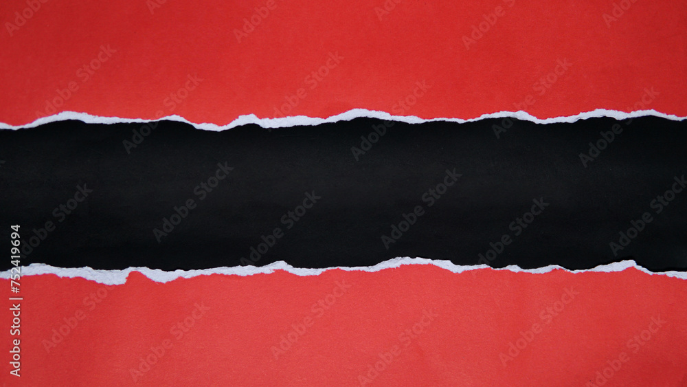 Torn red paper sheet isolated on black background Torn red paper sheet isolated on black background