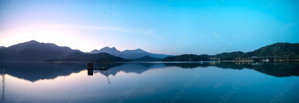 Before sunrise, the view of the dock with lakes and mountains. Sun Moon Lake is one of Taiwan's famous tourist attractions. Nantou county.