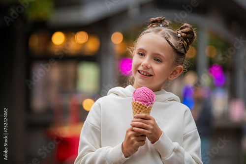 cute little girl eating ice cream outdoors.