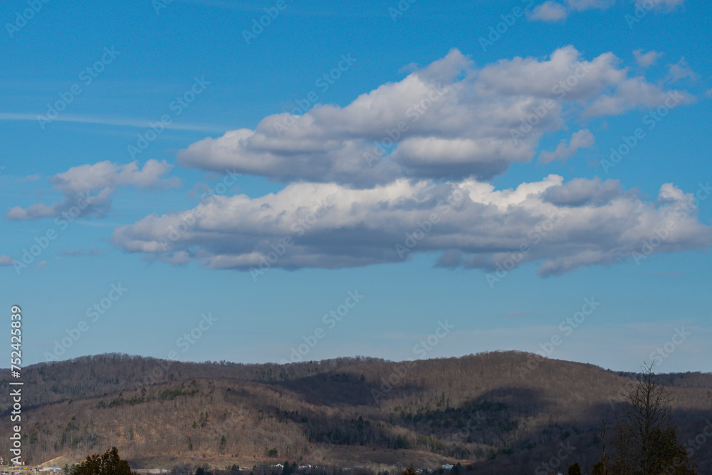 Copy space image of mountains late winter early spring bright day blue sky with some clouds Copy space image of mountains late winter early spring bright day blue sky with some clouds