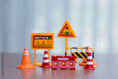 Traffic signs, cones and barrier on wood table. Road works concept.